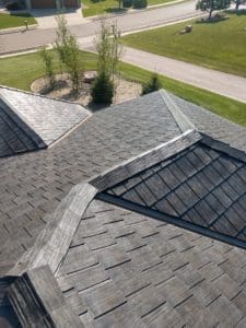 Grey shingles on a roof going in several different directions