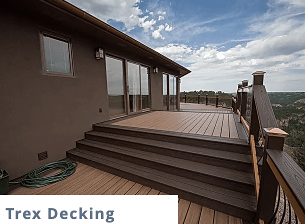 light brown wooden deck with dark brown edges and trex decking logo in the bottom left corner of the image