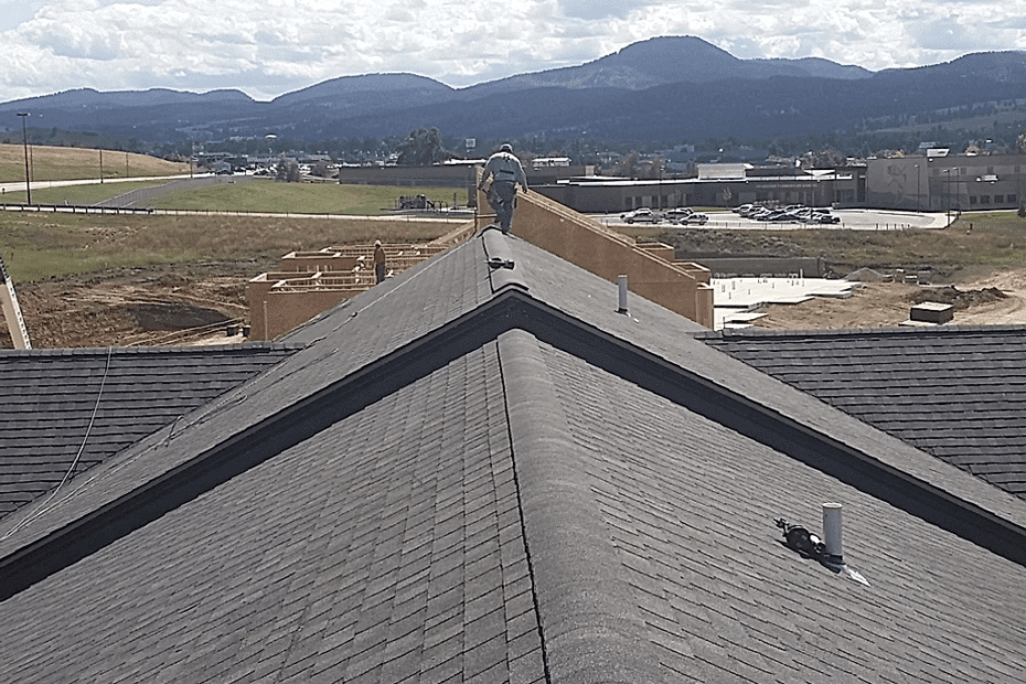 On top of a roof looking off toward distant mountains with a city at the base