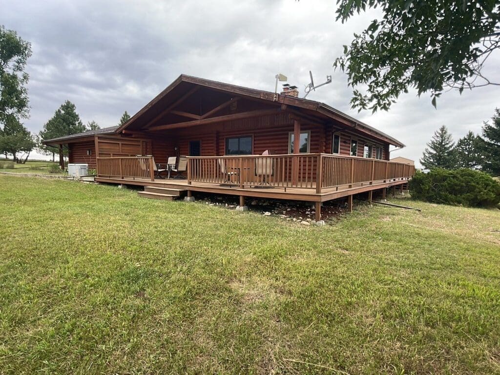 Log cabin located in Rapid City South Dakota wiht wrap around deck